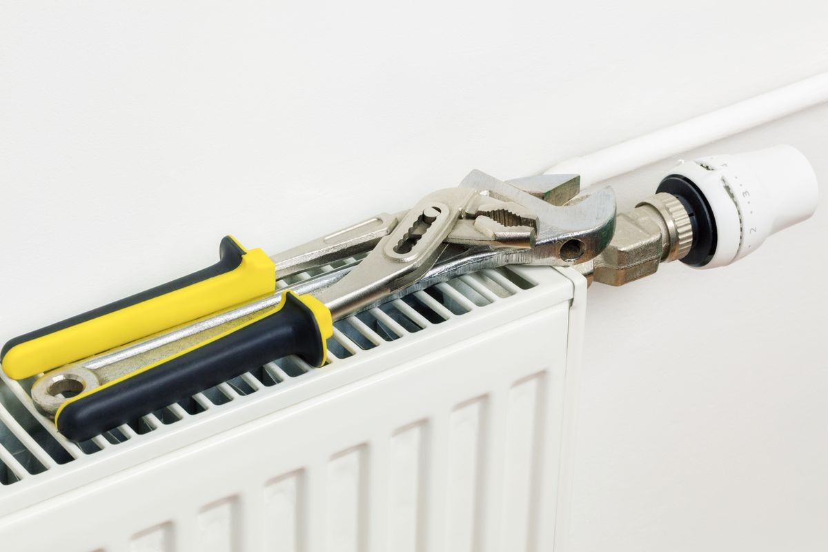 Plumbing tools on the heating radiator